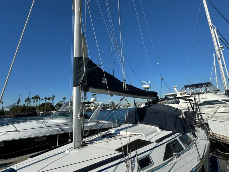 1992 Hunter 35 sailboat docked in marina under clear blue sky.