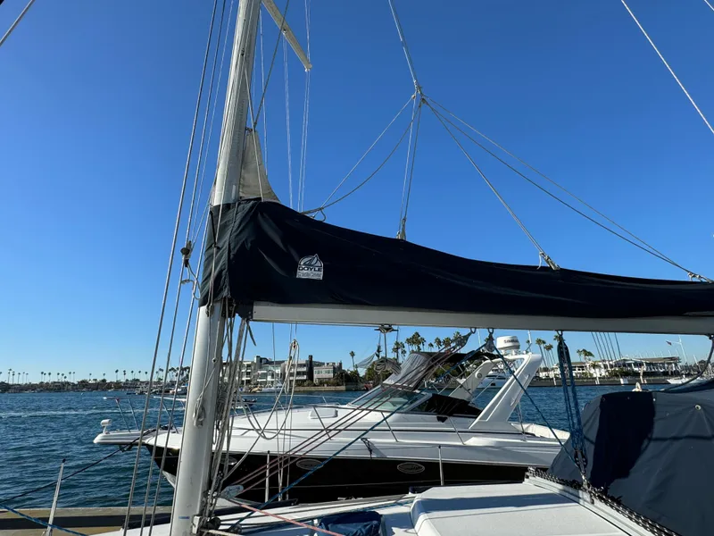Sailboat docked at marina, Hunter 35 model, 1992, under clear blue sky.