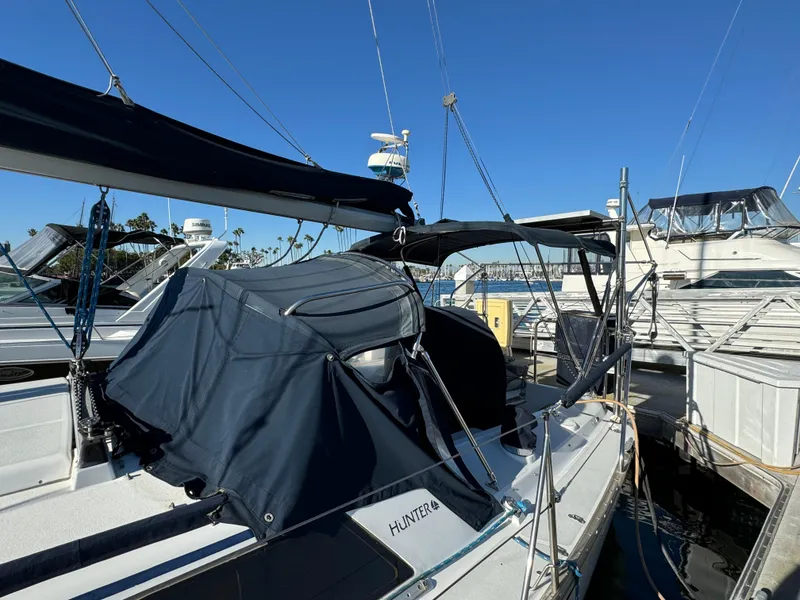 1992 Hunter 35 sailboat docked at marina under clear blue sky.
