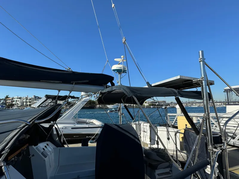 Sailboat Hunter 35, 1992 model, docked at marina under clear blue sky.