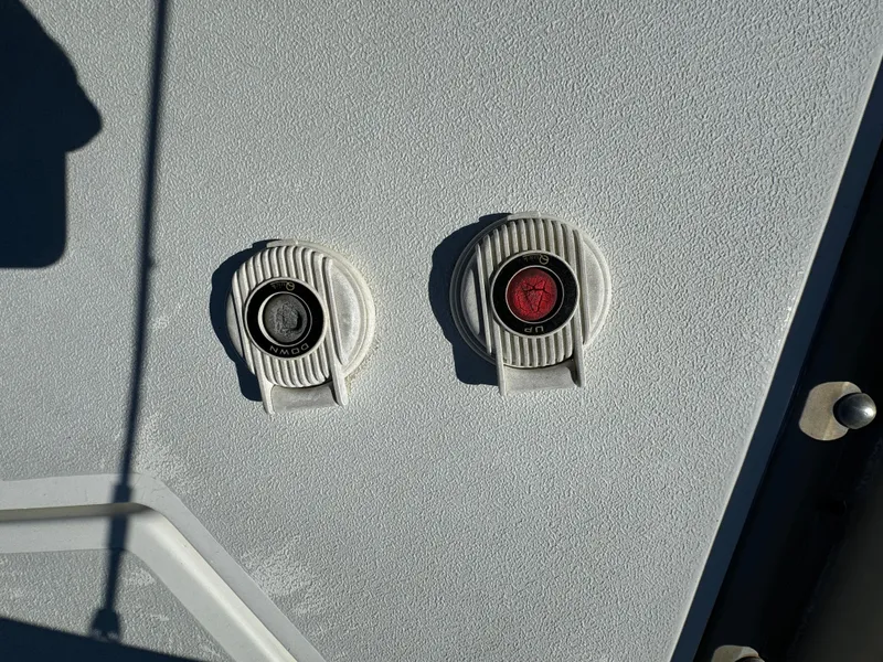 Two circular boat fittings on a 1992 Hunter 35 sailboat deck.