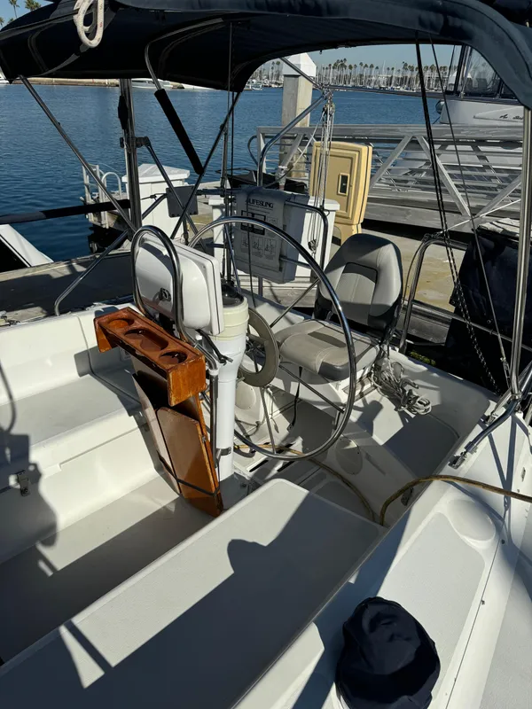 1992 Hunter 35 sailboat cockpit with steering wheel, docked at marina.