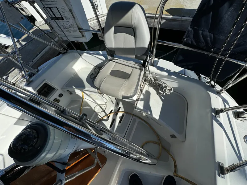 Cockpit of 1992 Hunter 35 sailboat with steering wheel and cushioned seat.