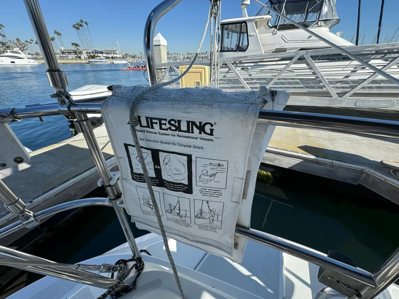 Lifesling rescue system on a 1992 Hunter 35 sailboat docked at a marina.
