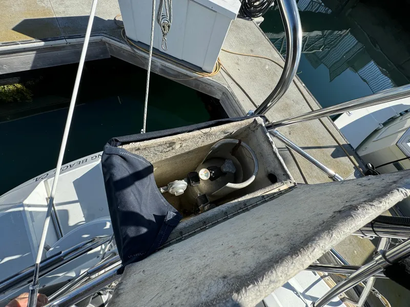 Sailboat deck with open compartment, Hunter 35, 1992 model, docked at marina.