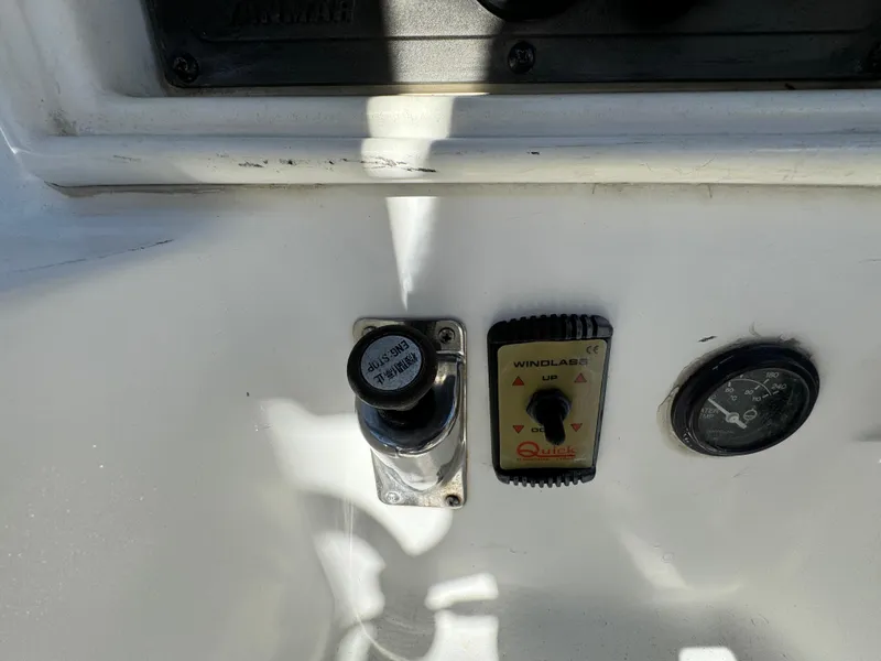 Control panel of a 1992 Hunter 35 boat with windlass switch and gauge.