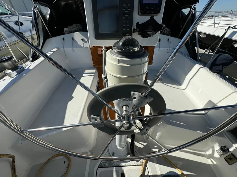Cockpit of a 1992 Hunter 35 sailboat with steering wheel and navigation equipment.
