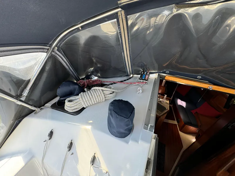 1992 Hunter 35 sailboat cockpit with ropes and covered equipment, interior view visible.
