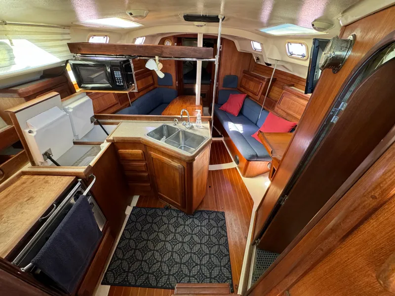 Interior of 1992 Hunter 35 sailboat with kitchen, seating, and wooden finishes.