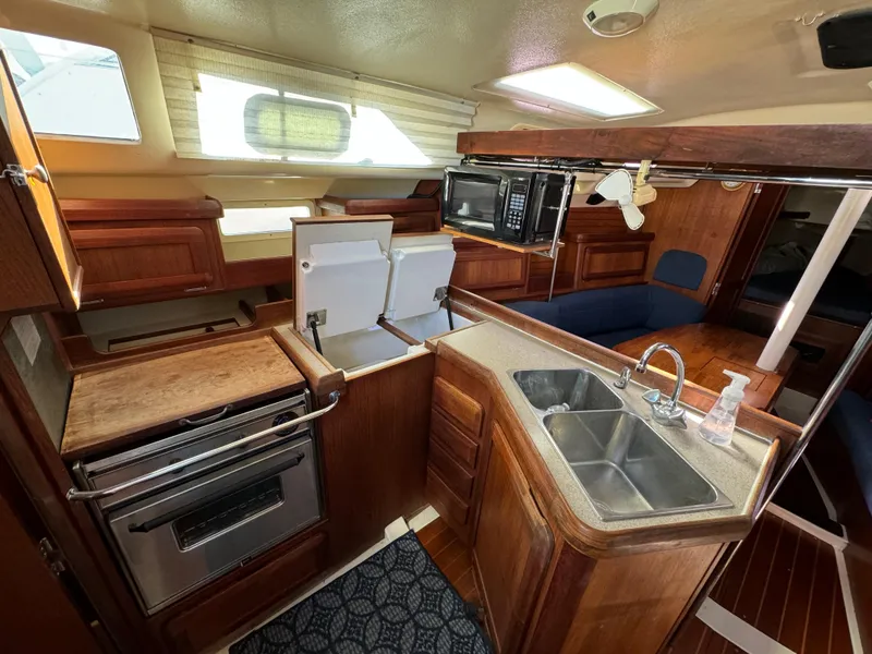 Interior of a 1992 Hunter 35 sailboat with kitchen and seating area.