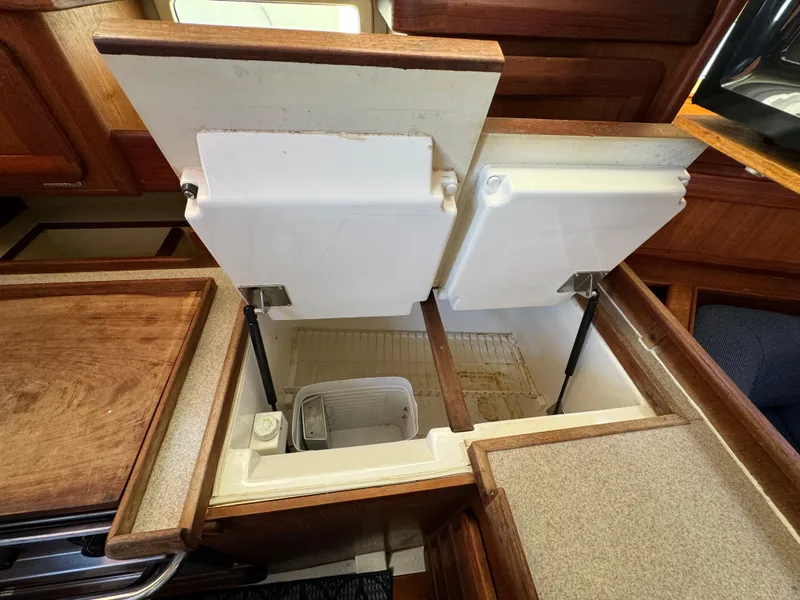 1992 Hunter 35 yacht interior with open storage compartments in the galley area.