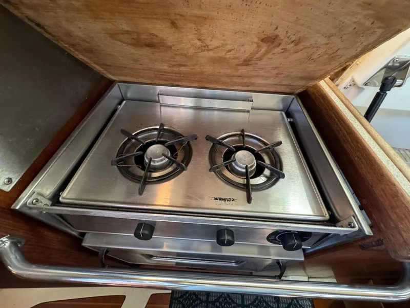 Stainless steel two-burner stove in a 1992 Hunter 35 sailboat galley.