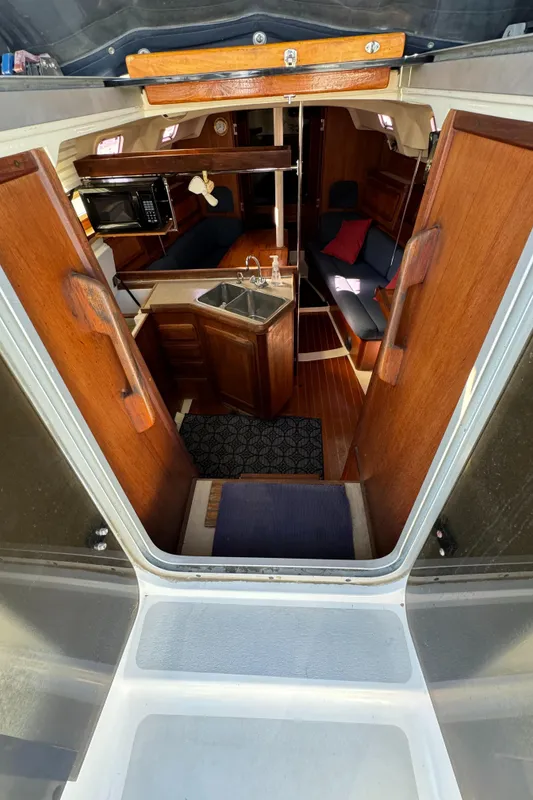 Interior view of a 1992 Hunter 35 sailboat, featuring a cozy cabin with wooden finishes.
