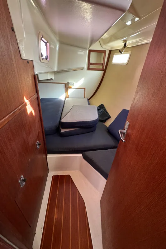 Cozy cabin interior of 1992 Hunter 35 sailboat with wooden finishes and cushions.