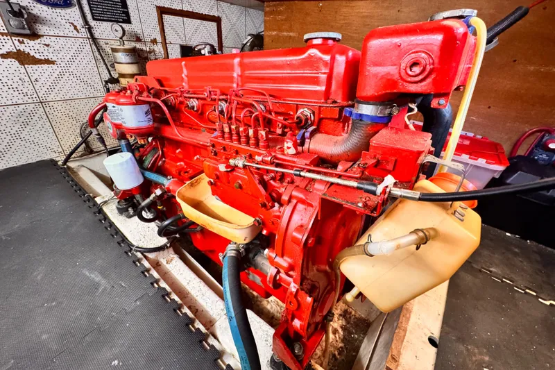 Red engine of a 1980 Hershine Trawler, showcasing detailed mechanical components.