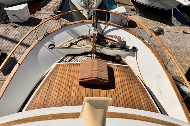 1980 Hershine Trawler boat deck with wooden flooring and nautical equipment.