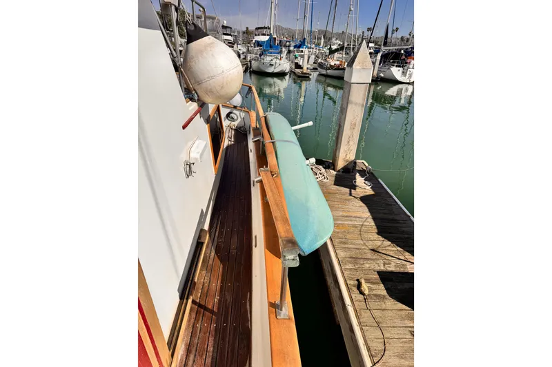 1980 Hershine Trawler docked, featuring wooden deck and marina view.