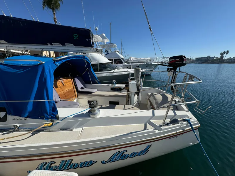 1987 Catalina 34 sailboat docked in marina under clear blue sky.
