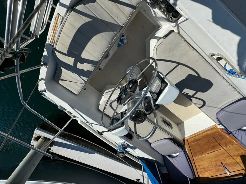 1987 Catalina 34 sailboat cockpit with steering wheel and seating, viewed from above.