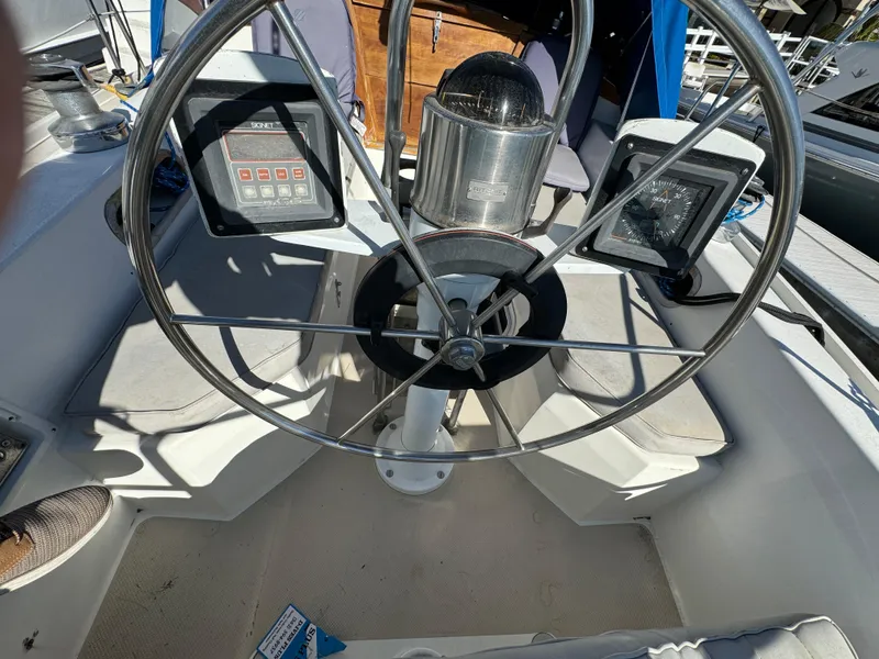 Steering wheel and instruments on a 1987 Catalina 34 sailboat cockpit.