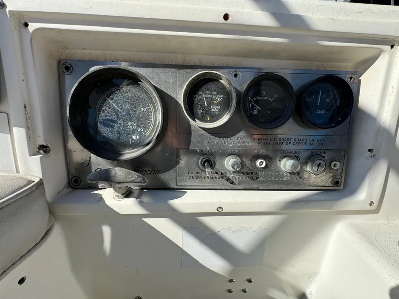 Control panel of a 1987 Catalina 34 sailboat with gauges and switches.