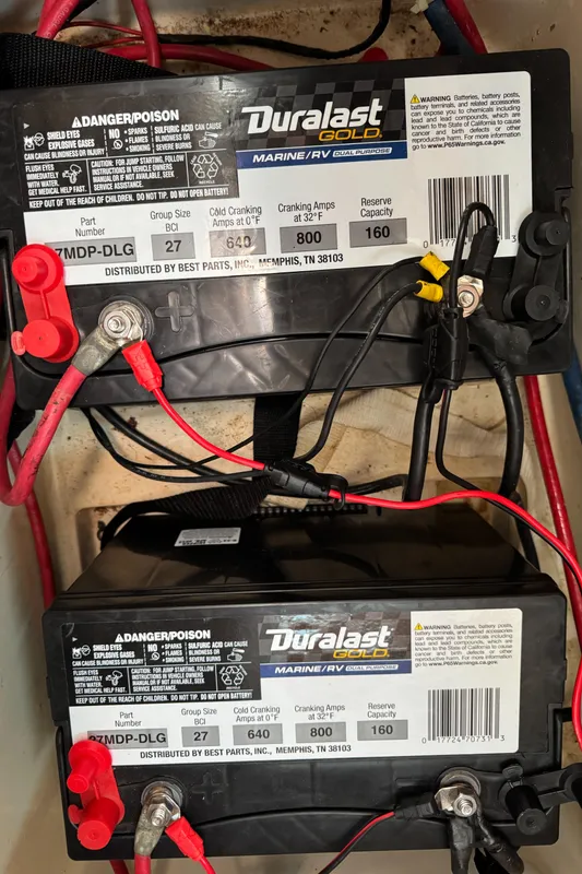 Duralast marine batteries in a 1987 Catalina 34, connected with red and black cables.