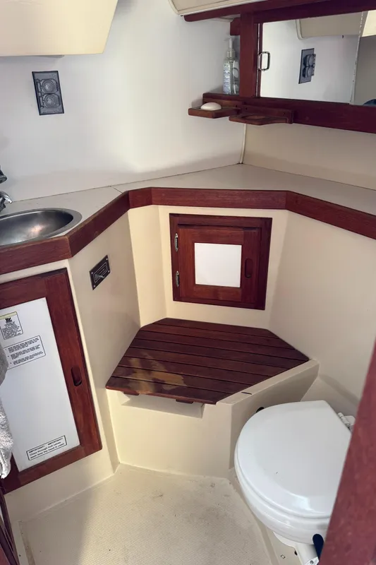 1987 Catalina 34 yacht bathroom with wooden accents and compact design.