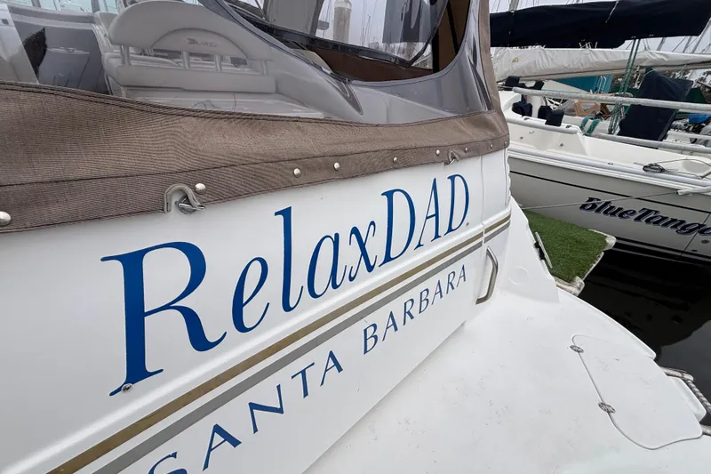 Larson 310 boat named "RelaxDAD" docked in Santa Barbara, 2004 model.