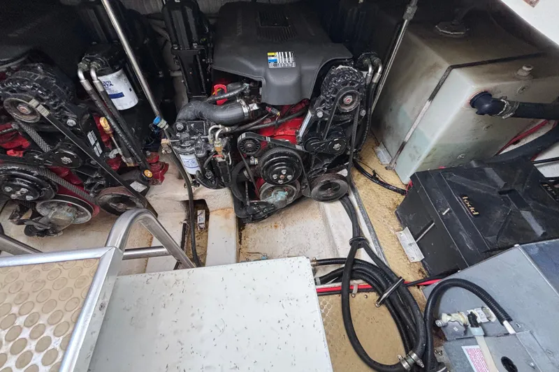 Engine compartment of a 2004 Larson 310 boat, showing dual engines and mechanical components.