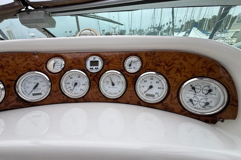 Dashboard of a 2004 Larson 310 boat with various gauges and controls.