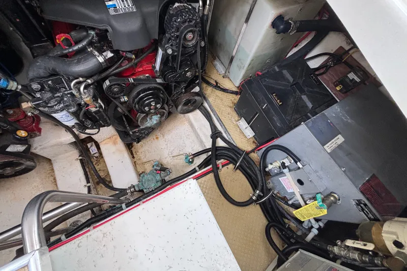 Engine compartment of a 2004 Larson 310 boat, showcasing mechanical components and wiring.