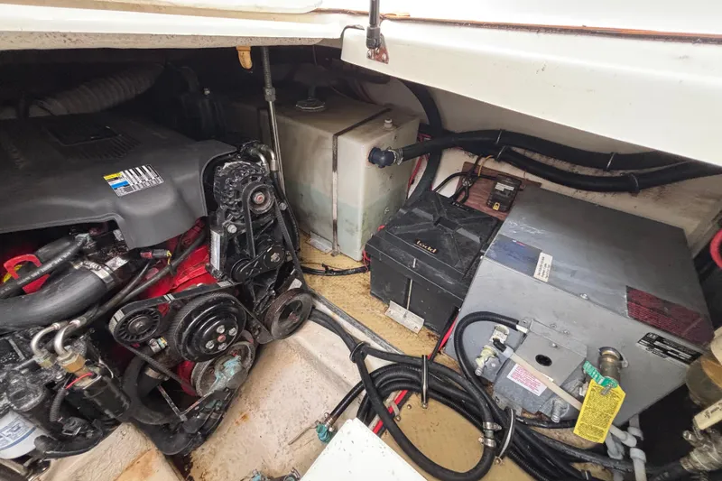 Engine compartment of a 2004 Larson 310 boat, showing engine and components.