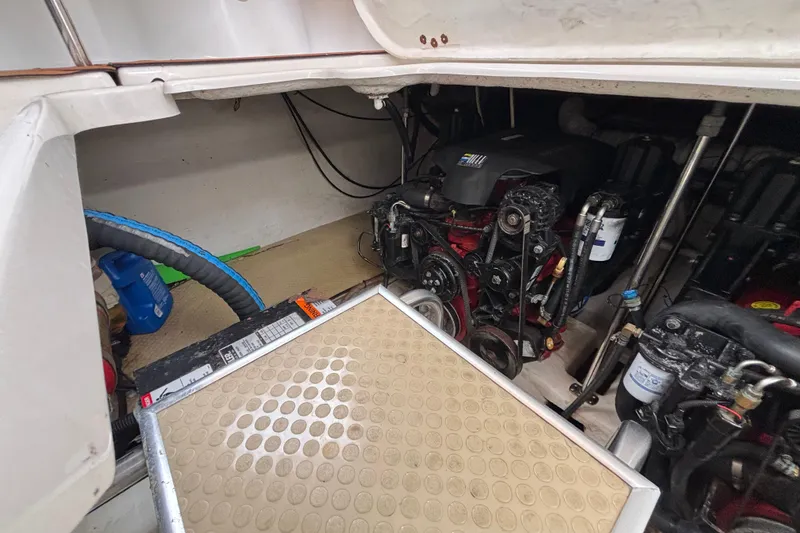 Engine compartment of a 2004 Larson 310 boat, showcasing mechanical components and hoses.