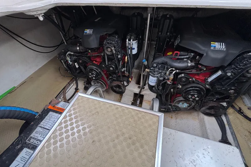 Engine compartment of a 2004 Larson 310 boat, showcasing dual engines and mechanical components.
