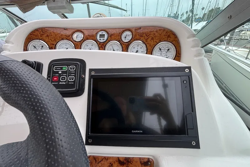 Dashboard of a 2004 Larson 310 boat with Garmin navigation system.