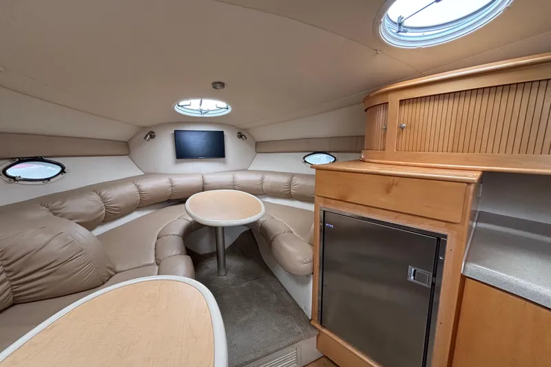 Interior of a 2004 Larson 310 boat with cozy seating and modern amenities.