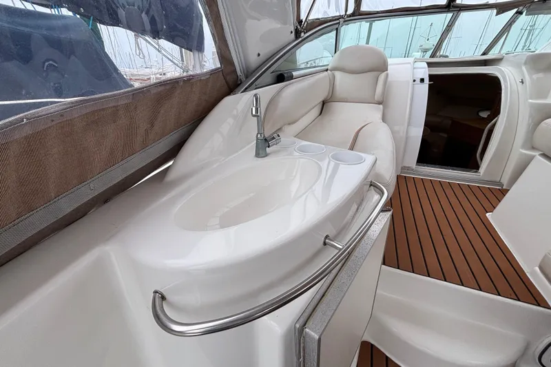 Interior of a 2004 Larson 310 boat featuring a sleek sink and comfortable seating.