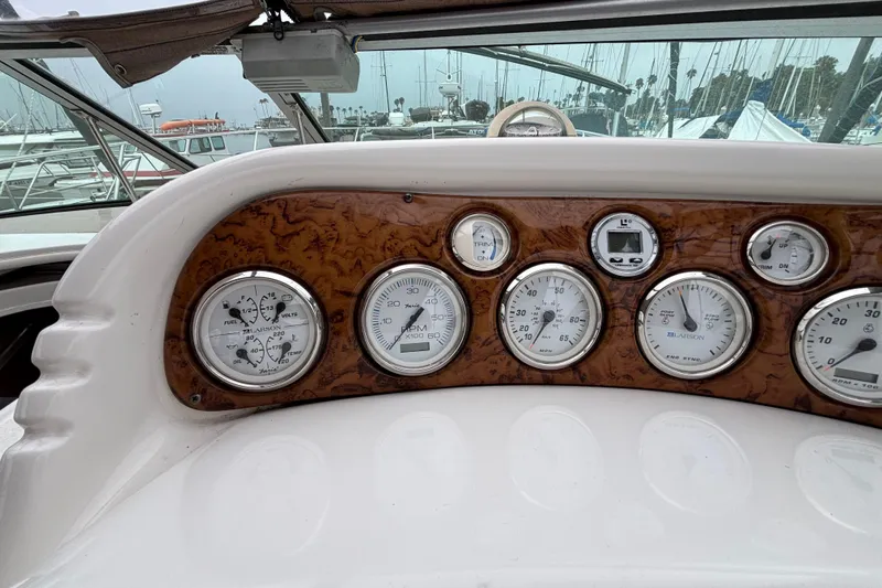 Dashboard of a 2004 Larson 310 boat with various gauges and controls.