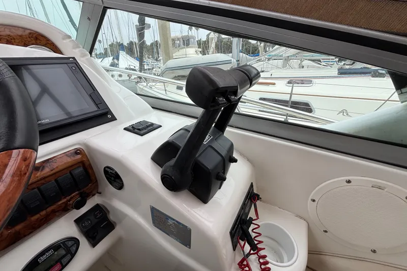Cockpit of a 2004 Larson 310 boat with navigation controls and display.