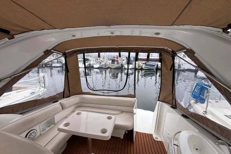 Interior view of a 2004 Larson 310 boat with marina backdrop.