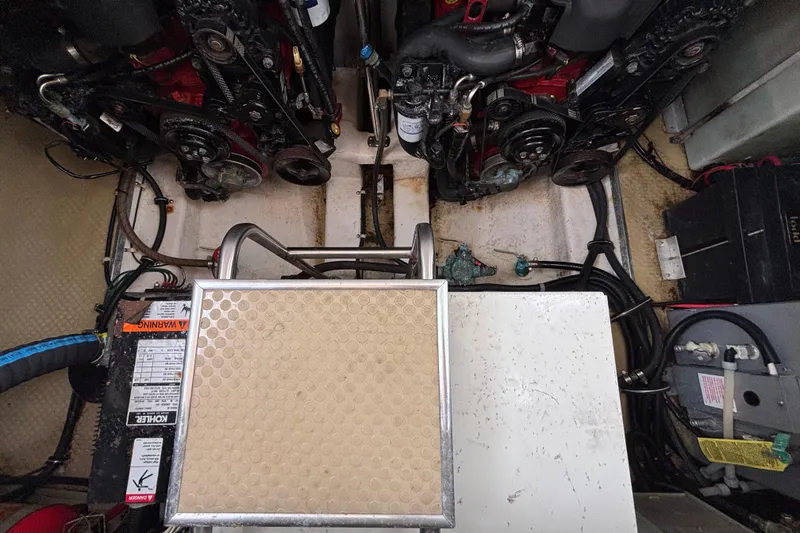 Engine compartment of a 2004 Larson 310 boat, showcasing dual engines and mechanical components.
