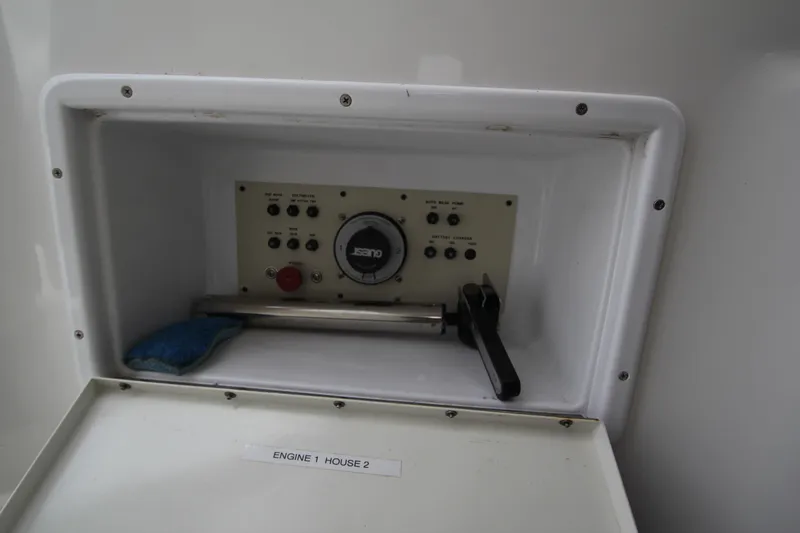 A control panel with buttons and a gauge inside a white compartment.