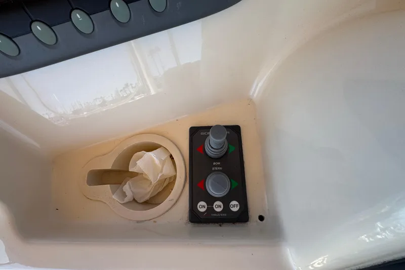 Control panel of a 2006 Mainship 34 Trawler with joystick and cup holder.