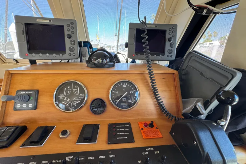 2006 Mainship 34 Trawler helm with navigation screens and control panel.