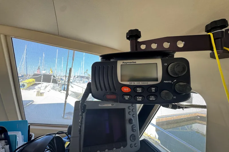 2006 Mainship 34 Trawler interior with Raymarine VHF radio and marina view.
