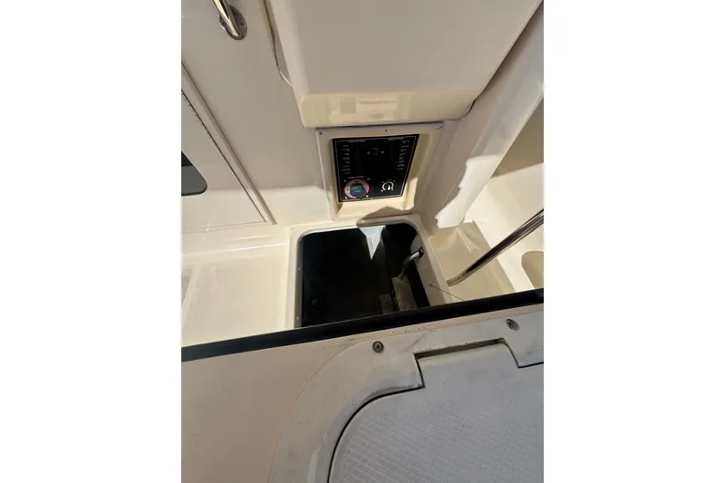 2006 Mainship 34 Trawler interior with control panel and storage compartment.