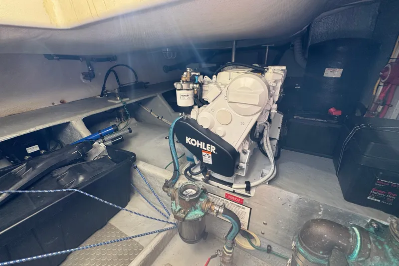 Engine room of a 2006 Mainship 34 Trawler featuring a Kohler generator.