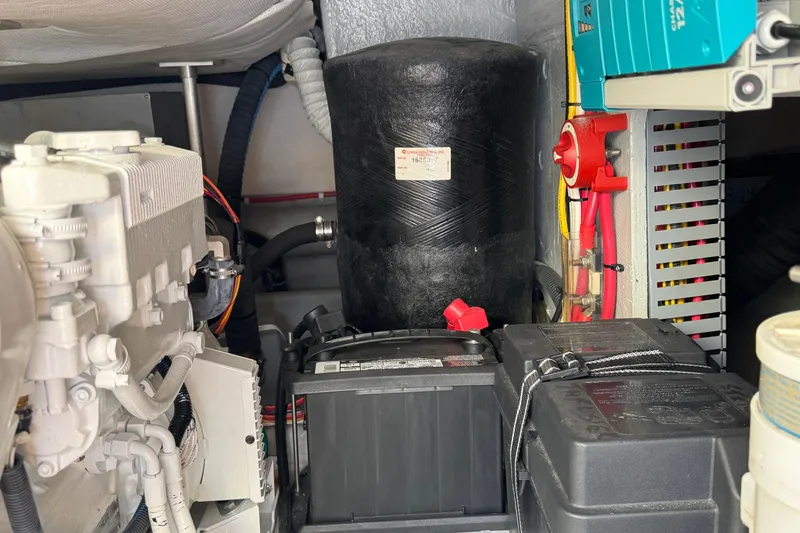 Engine room of 2006 Mainship 34 Trawler with battery and mechanical components.