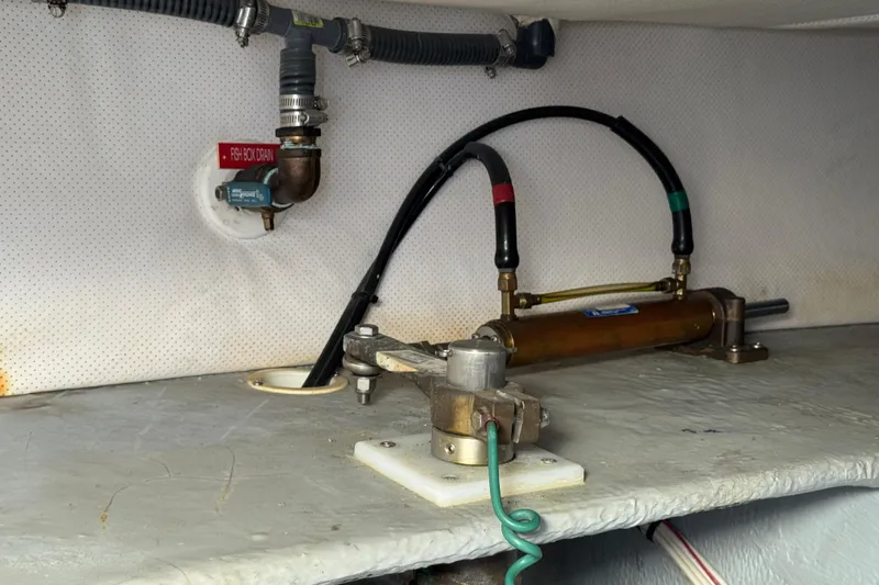 2006 Mainship 34 Trawler interior showing fish box drain and hydraulic components.
