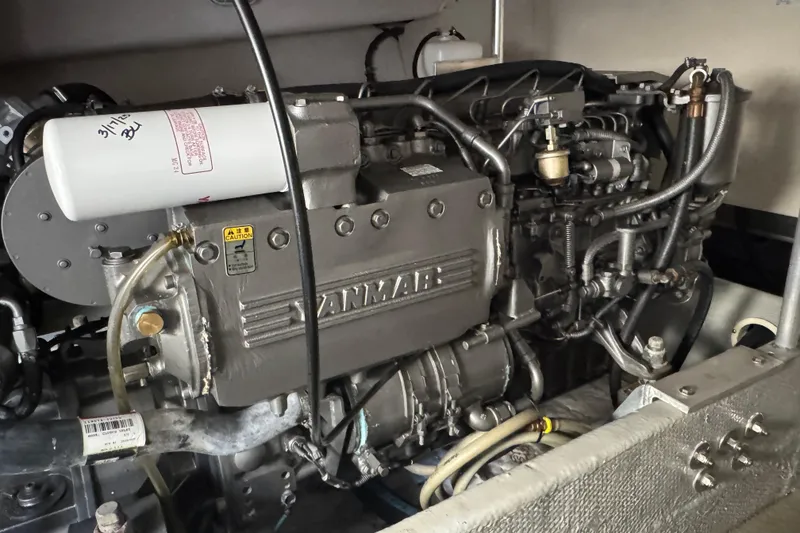 Engine of 2006 Mainship 34 Trawler, featuring Yanmar components and detailed mechanical parts.
